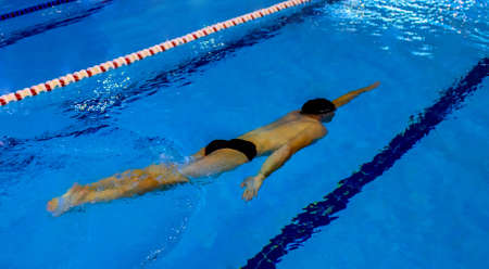Young man swims under the waterの写真素材