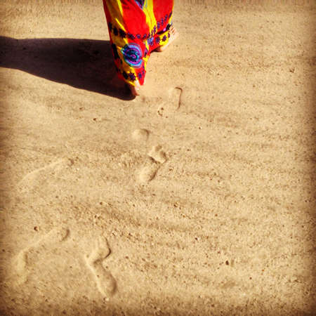 A female leaving sets of footsteps の素材