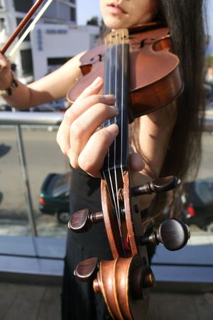 a musician performing with a violin on the balcony.の写真素材