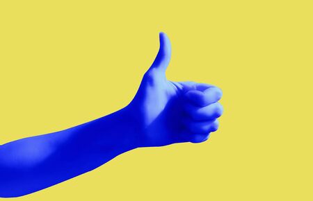 Blue hand gesture on yellow background poster. Like. Thumb up.の写真素材
