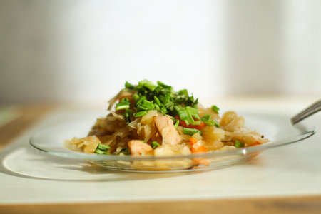 Stewed vegetables cabbage with meat in a glass plateの写真素材