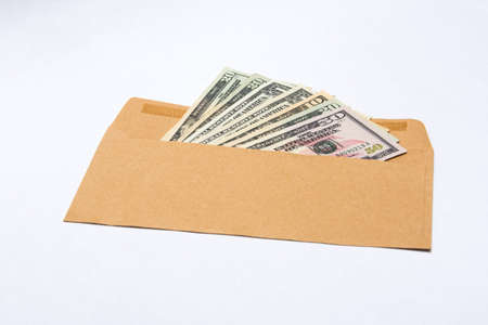 Dollars banknotes in a paper envelopeの写真素材