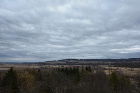 A gray cloudy sky over a wild valleyの写真素材