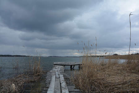 Old wooden pier by the lakeの写真素材
