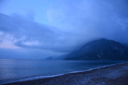 Early dawn in a Mediterranean bay with a rocky shoreの写真素材