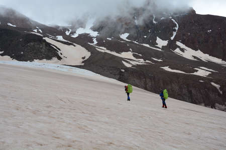 Two men go to the end of the glacier