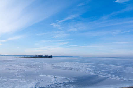 The surface of the reservoir is covered with ice and snow in winter.の写真素材