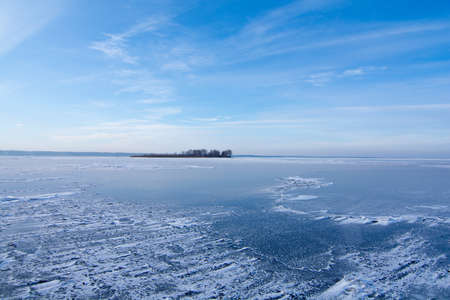 The surface of the reservoir is covered with ice and snow in winter.の写真素材