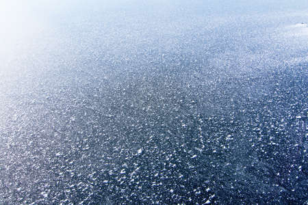 The surface of the reservoir is covered with ice and snow in winter.の写真素材