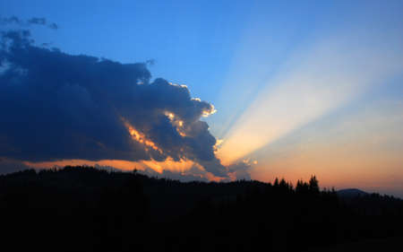 Mystical sunset in the mountains with the rays of the setting sun