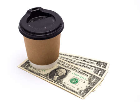 A glass of coffee and a few American dollar billsの写真素材