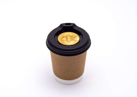 A cup of coffee on the road and bitcoinの写真素材