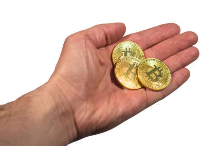 man's hand holds three coins of digital currency - bitcoinの写真素材