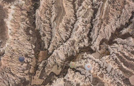 Cappadocia view from above with balloons on the red canyonの写真素材