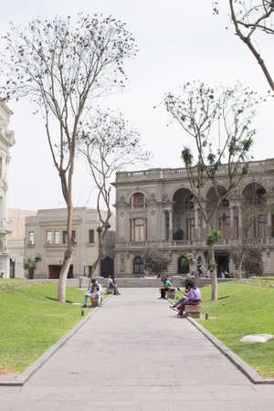 LIMA, PERU - AUG 29TH 2015: Several people are resting in the pews of Plaza San Martin in the city of Limaのeditorial素材