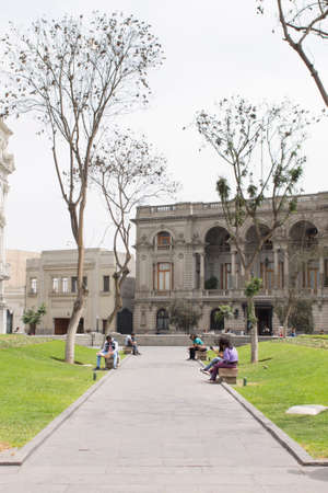 LIMA, PERU - AUG 29TH 2015: Several people are resting in the pews of Plaza San Martin in the city of Limaのeditorial素材