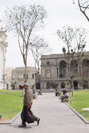 LIMA, PERU - AUG 29TH 2015: Several people are resting in the pews of Plaza San Martin in the city of Limaのeditorial素材