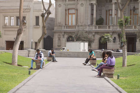 LIMA, PERU - AUG 29TH 2015: Several people are resting in the pews of Plaza San Martin in the city of Limaのeditorial素材