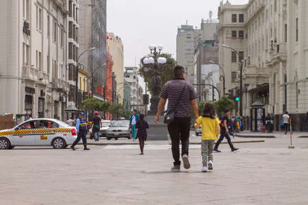LIMA, PERU - AUG 29TH 2015: Father and daughter walking and exploring the streets of the city of Lima, Peruのeditorial素材