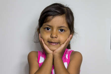 Cute smiling girl with her hands on her face
