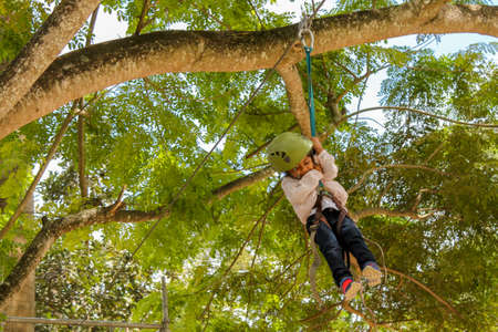 Cute girl practicing canopy from the heights in Caracas, Venezuela.の写真素材