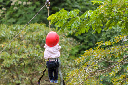 Cute girl practicing canopy from the heights in Caracas, Venezuela.の写真素材