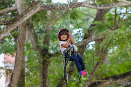 Cute girl practicing canopy from the heights in Caracas, Venezuela.の写真素材