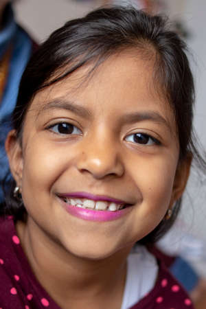 Cute brunette girl with pink lips smilingの写真素材