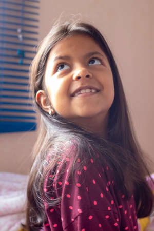 Cute brunette girl with pink lips smilingの写真素材