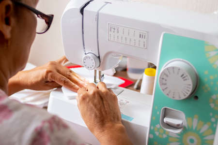 Woman seamstress doing work with her sewing machine
