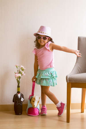 Little girl posing tenderly with sunglassesの写真素材