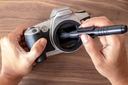 Performing a maintenance on a camera with toolsの写真素材