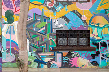 LIMA, PERU - JUL 18TH 2015: Window inside beautiful decorated wall in the streets of Lima, Peru