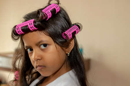 Tender girl playing with beauty accessoriesの写真素材