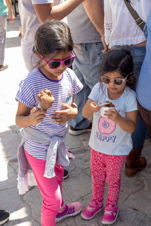 Cute girls with sunglasses eating a delicious ice creamの写真素材