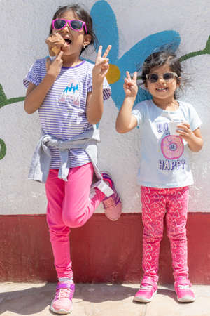 Cute girls with sunglasses eating a delicious ice creamの写真素材