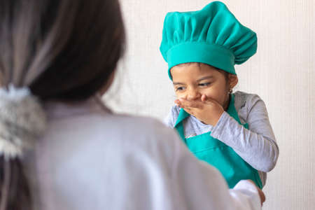 Cute smiling girl enjoying in the kitchenの写真素材