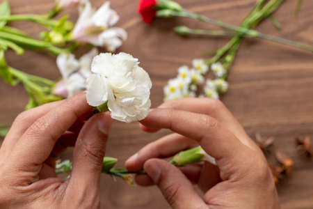 Holding flowers with handsの写真素材