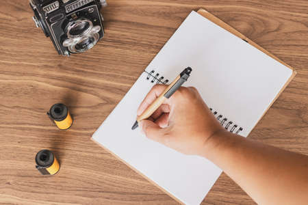 Taking notes of photography on the deskの写真素材