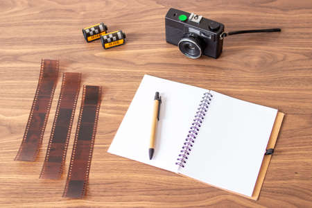 Checking the images of my analog camera, next to my notesの写真素材