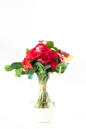 Arrangement of roses and red carnationsの写真素材