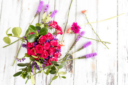 Arrangement of roses and red carnationsの写真素材