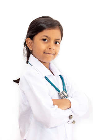 Cute little girl, playing doctor, posing with white coatの写真素材