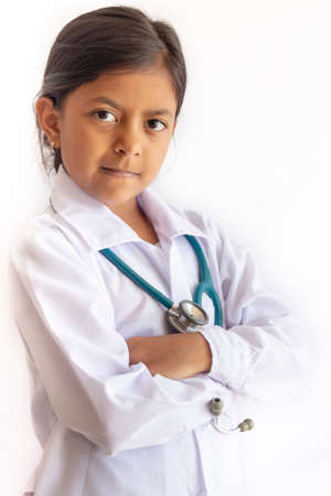 Cute little girl, playing doctor, posing with white coatの写真素材