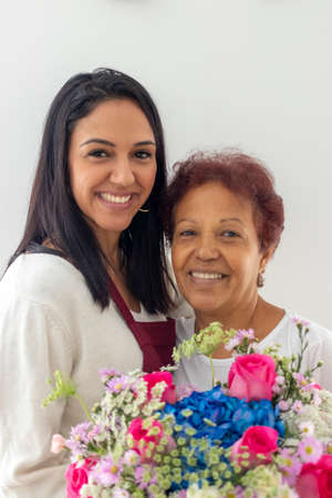 Smiling mother and daughter with their bouquet of flowersの写真素材