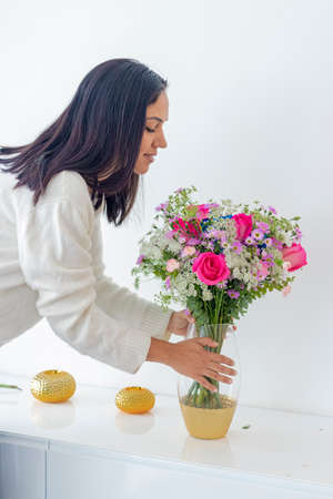 Cute brunette woman enjoying her bouquet of flowersの写真素材