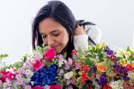 Cute brunette woman enjoying her bouquet of flowersの写真素材