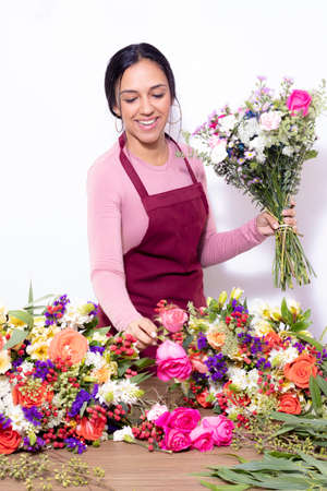 Brunette woman making bouquets at the florist shopの写真素材
