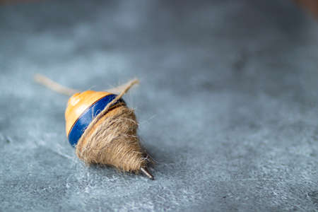 Classic wooden spinning top toy with stringの写真素材
