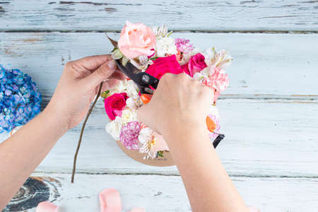 Florist preparing a bouquet of pink and red rosesの写真素材